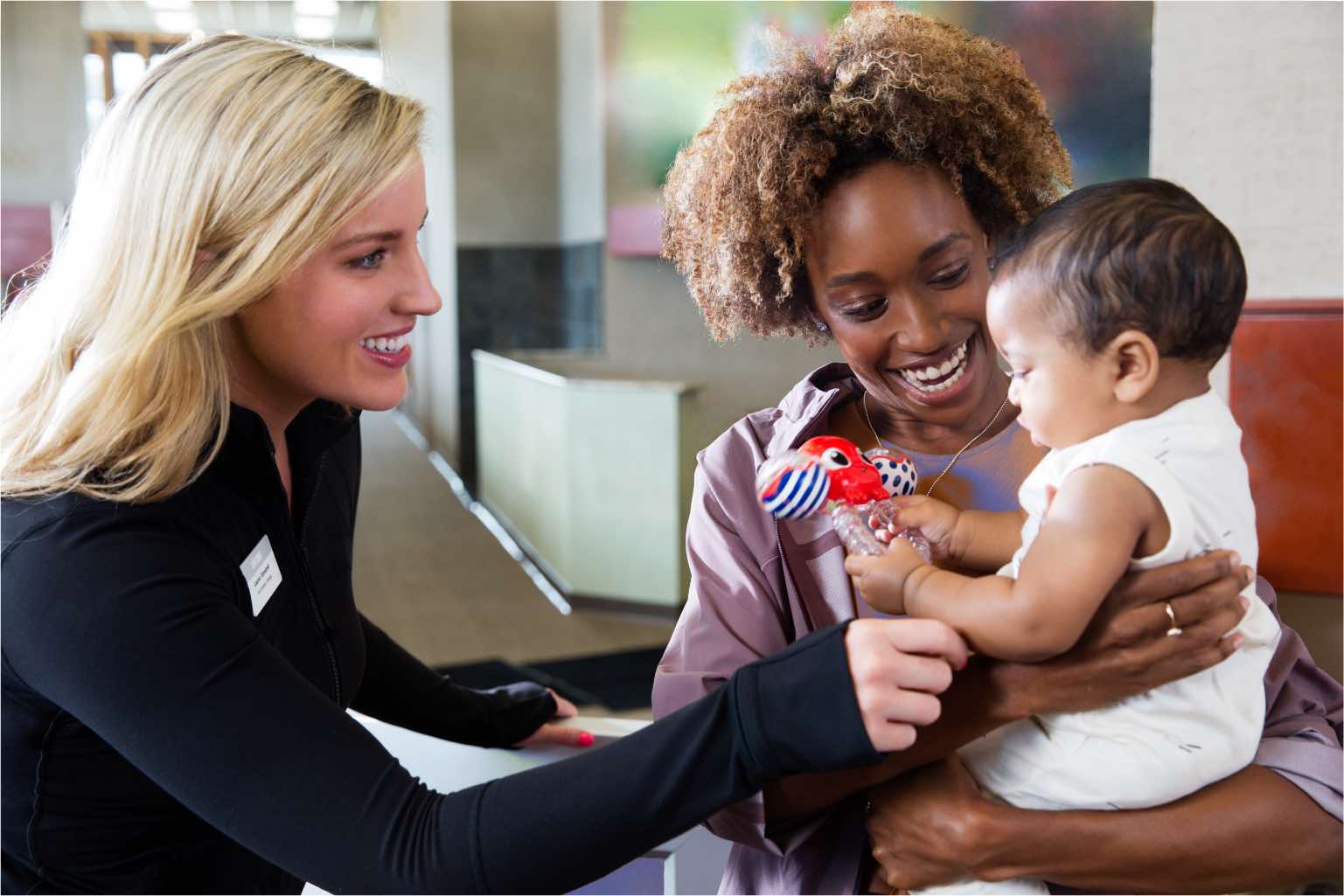 Female team member working with a mom and her daughter at a Kids Academy at Life Time. 