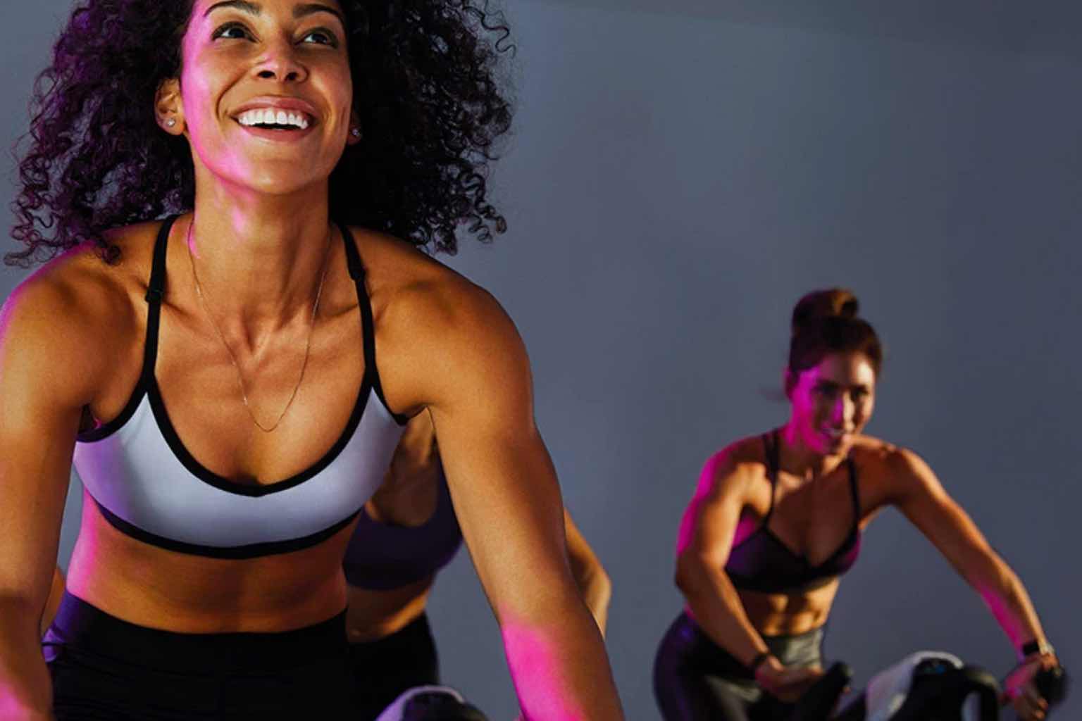 two women in a cycle class