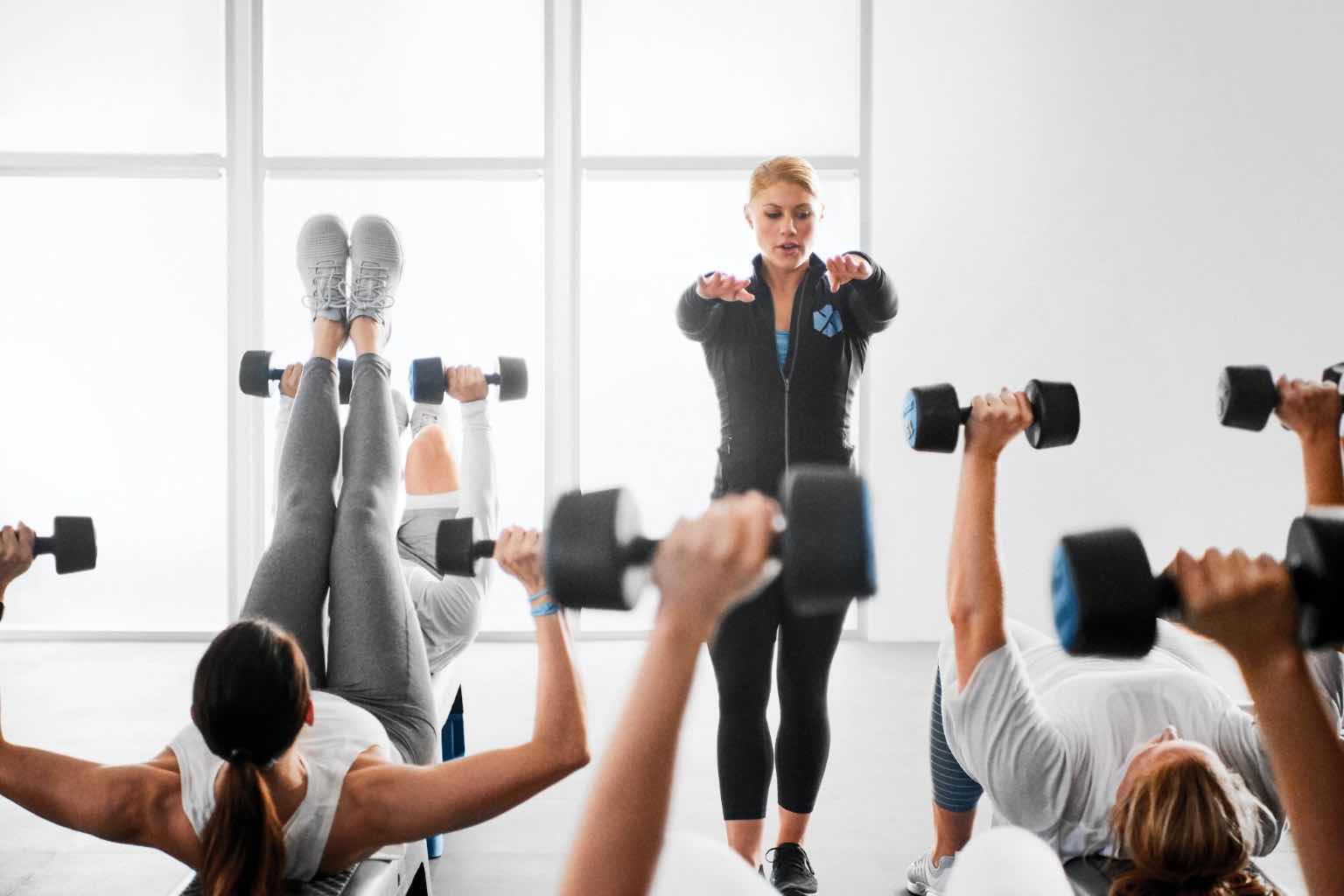 a life time instructor leading a group of individuals through a fitness class