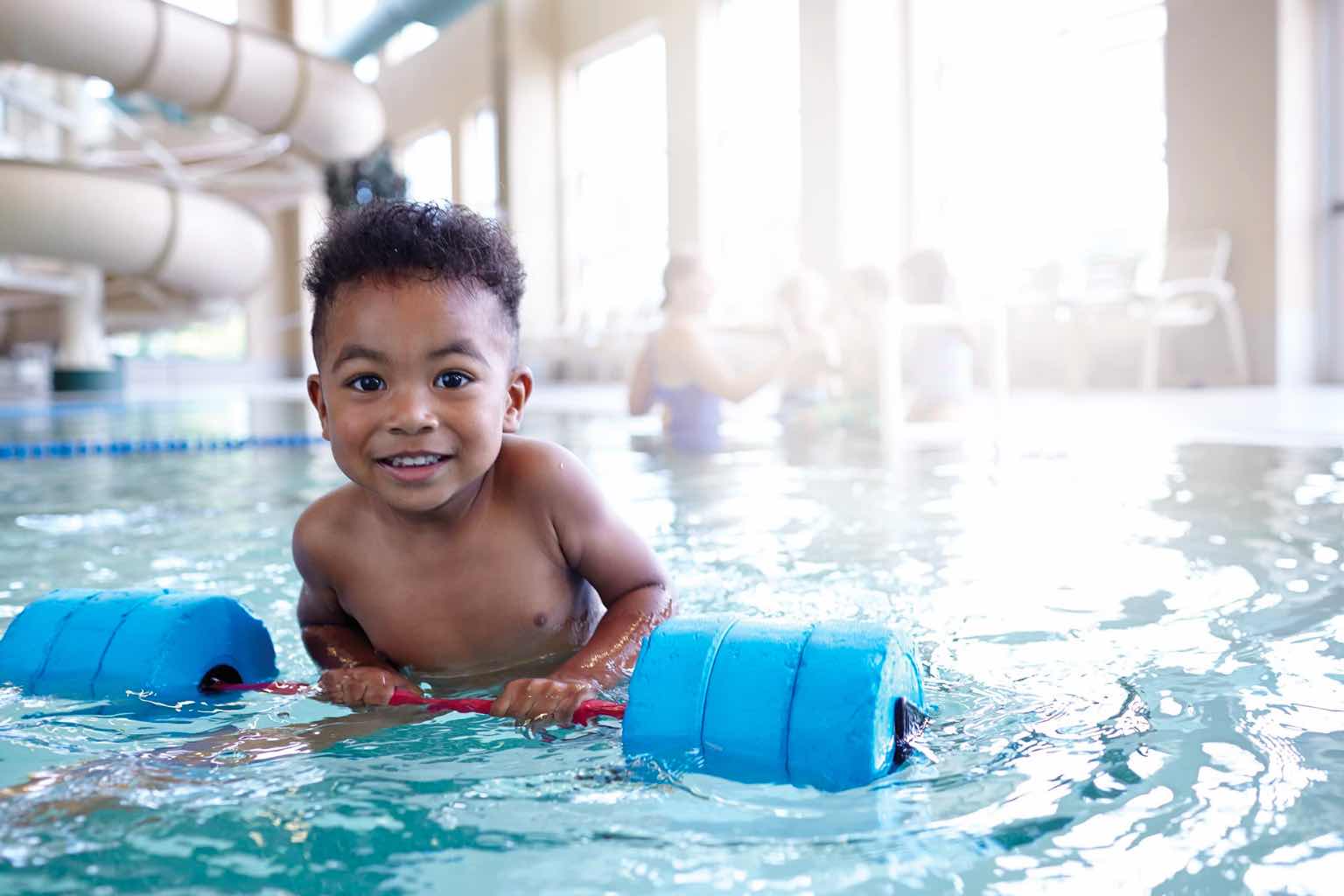 a little boy learning how to swim