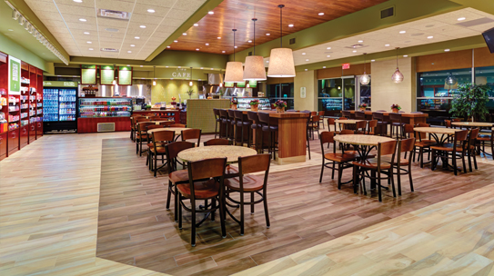 The interior of the Life Cafe with tables, chairs, and a counter to order food