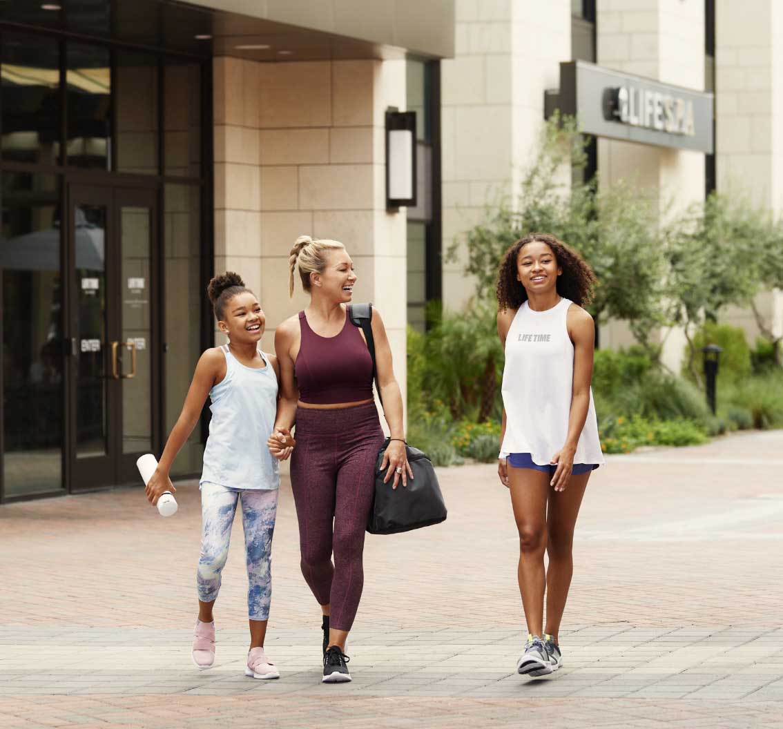 a mom and two daughter walking together