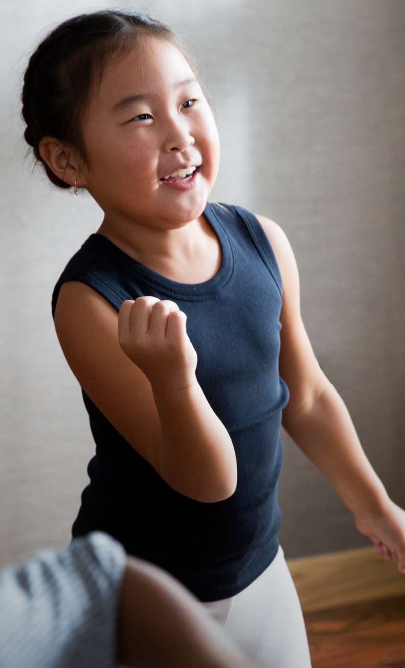 a group of children dance around in a studio