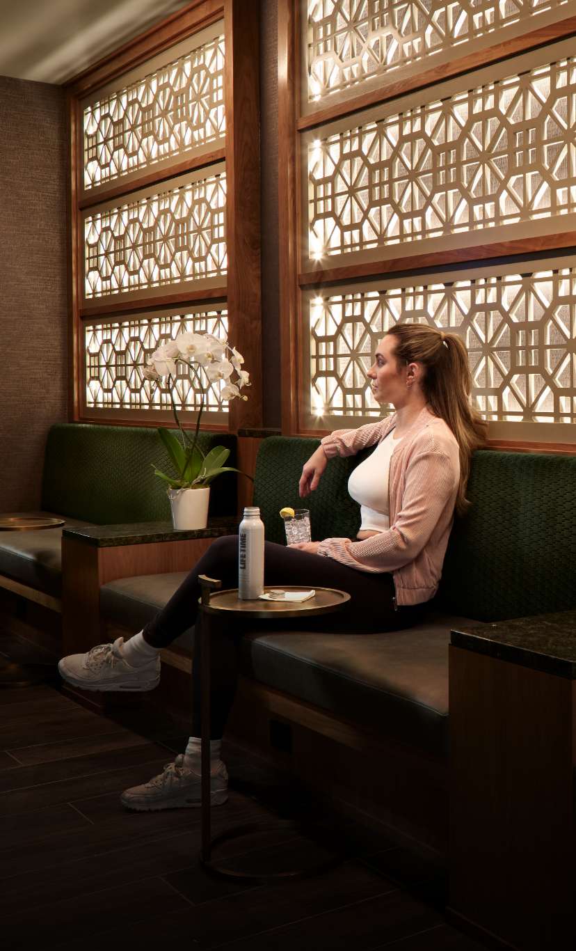 A woman relaxes at a cozy table in a cafe