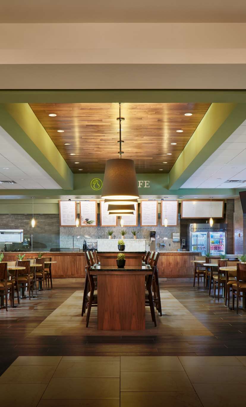 A brightly lit cafe with seating and ordering counter