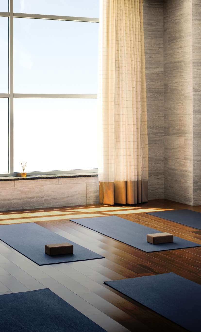yoga mats and yoga bricks laid out in a yoga studio
