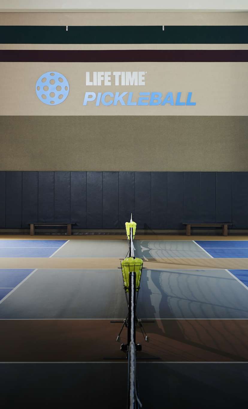dimly lit indoor pickleball courts