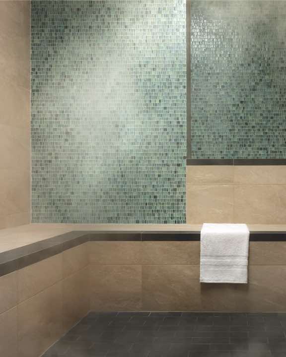 Peaceful steam room space with bench seating and tile walls