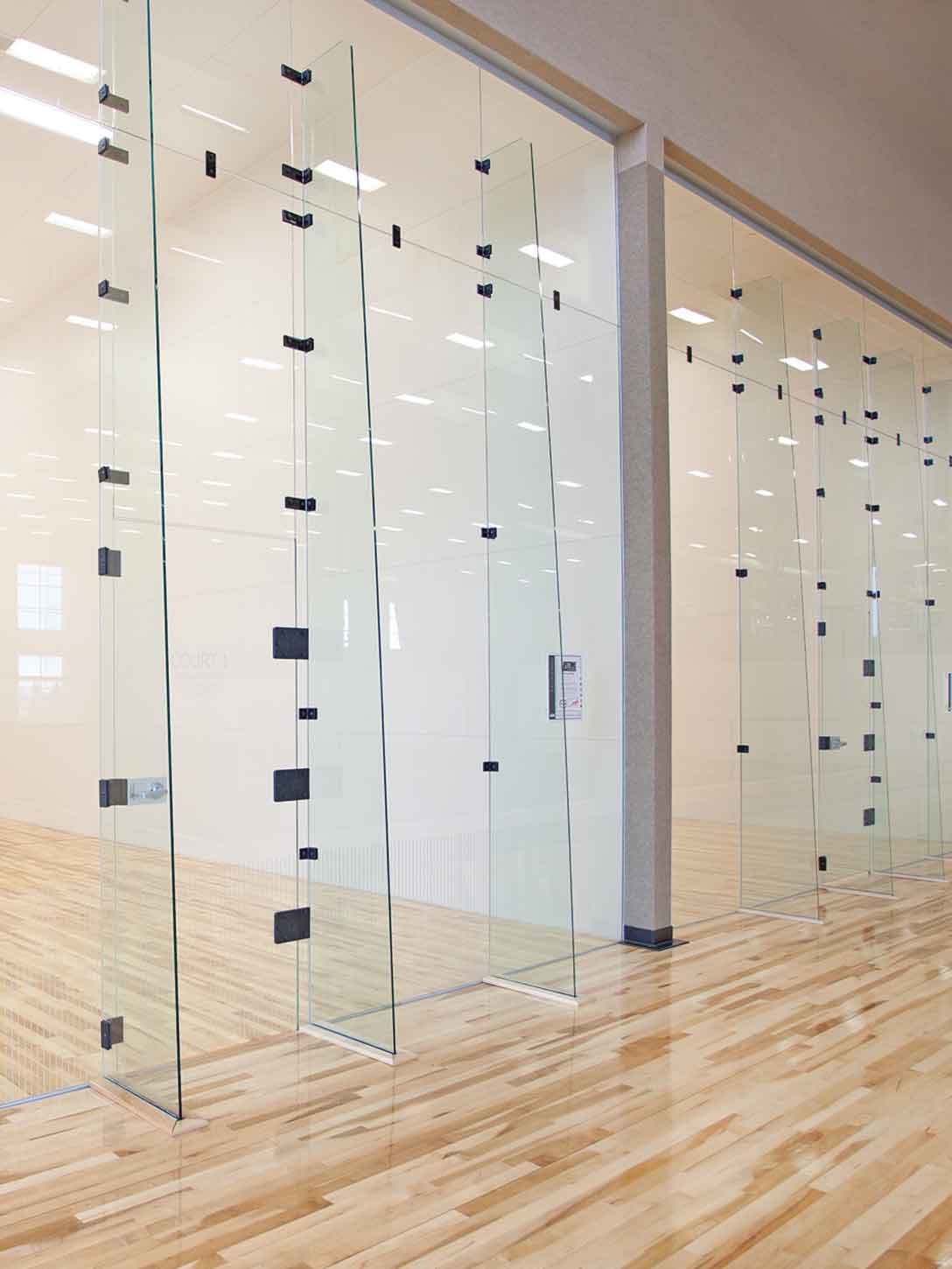 Brightly lit racquetball courts inside a Life Time club