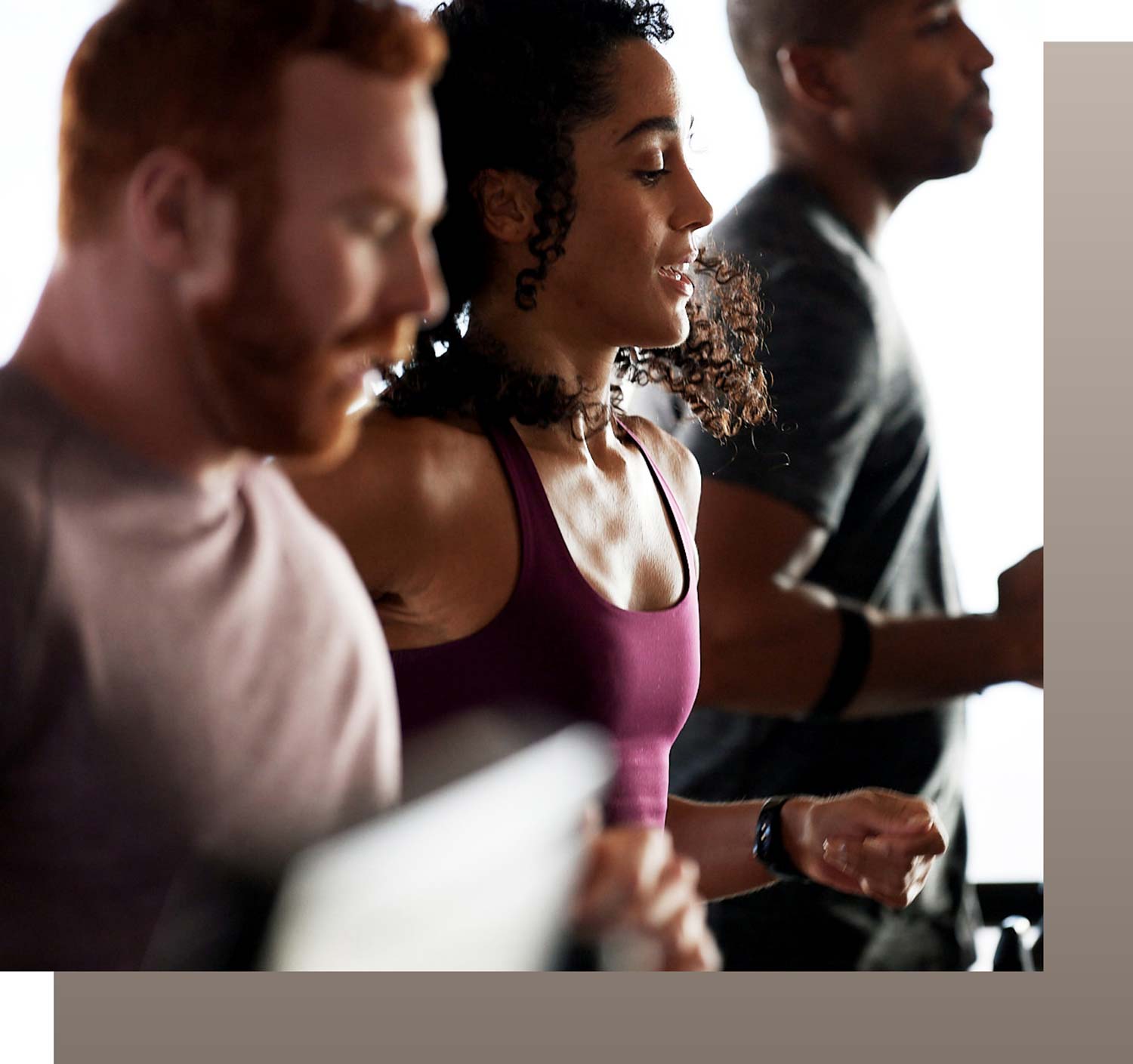 A profile shot of three GTX members running side by side on treadmills from the waist up.