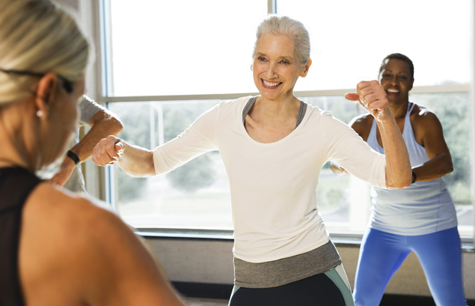 a group of people dance around in a studio