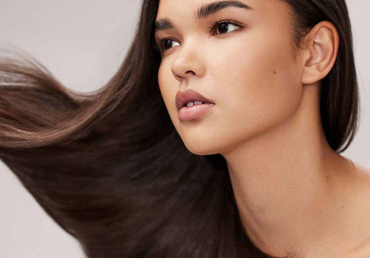 A woman swings her long hair