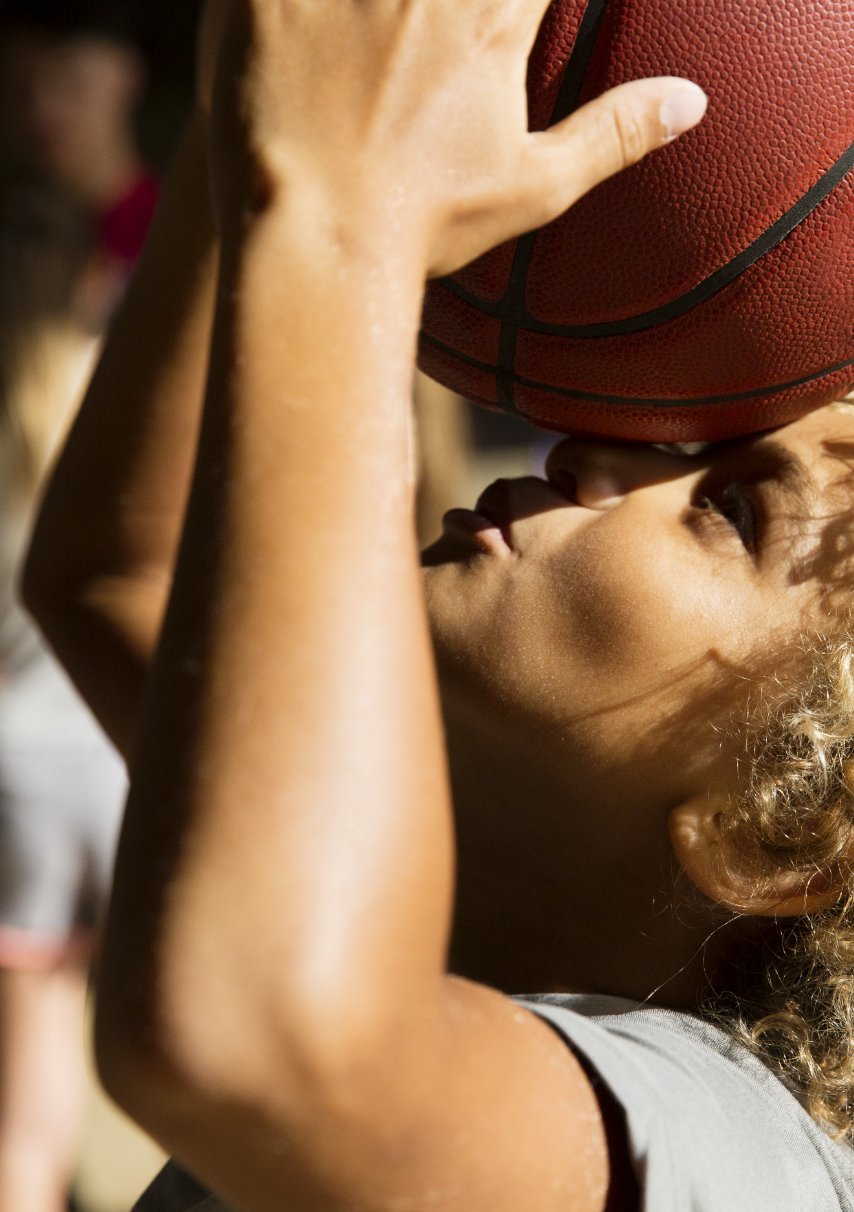 child playing with basketball