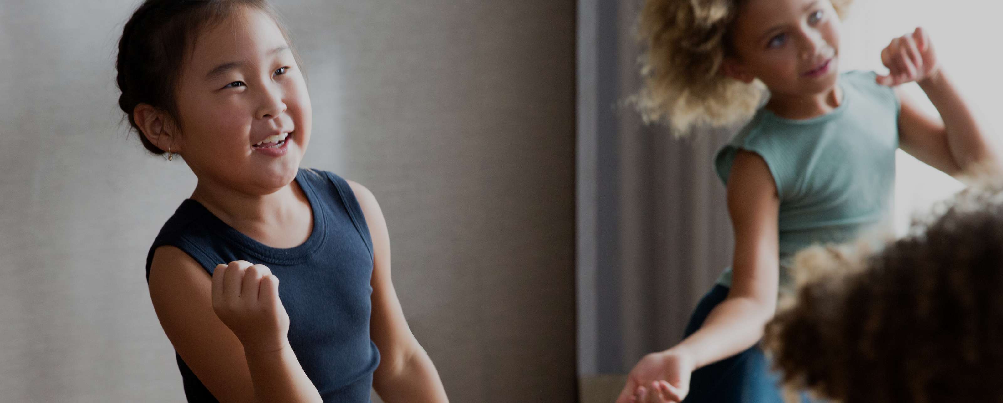 a group of children dance around a studio