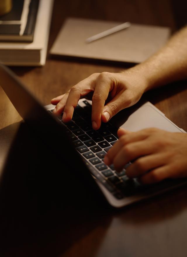 two hand typing on a lap top