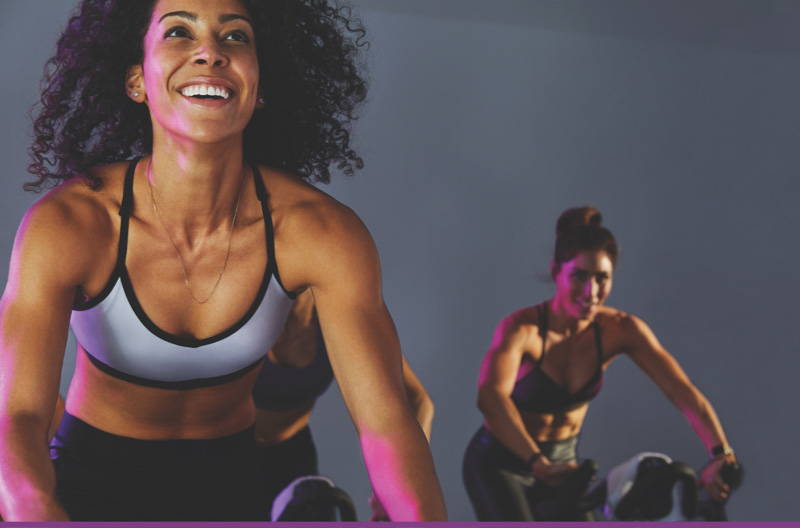 Woman riding a bike in Amp cycle class