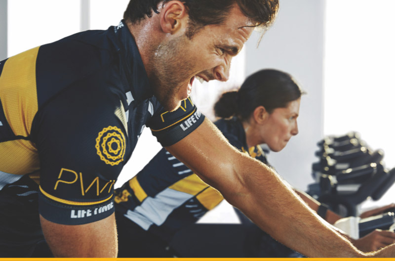 Guy cycling in a power class at Life time